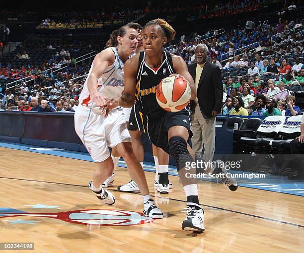 Amber Holt of the Tulsa Shock drives against Kelly Miller of the Atlanta Dream at Philips Arena on June 23, 2010 in Atlanta, Georgia. NOTE TO USER:...