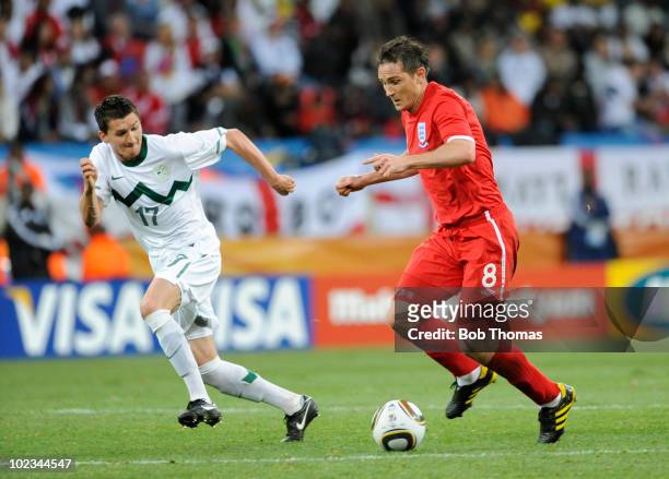 Frank Lampard of England with Andraz Kirm of Slovenia during the 2010 FIFA World Cup South Africa Group C match between Slovenia and England at the...