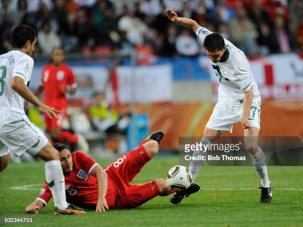 Frank Lampard of England is tackled by Andraz Kirm of Slovenia during the 2010 FIFA World Cup South Africa Group C match between Slovenia and England...
