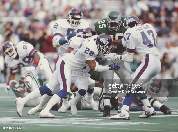 Anthony Toney, Running Back for the Philadelphia Eagles is tackled by Everson Walls and Greg Jackson, Defensive Backs for the New York Giants during...