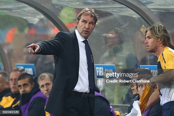 Pim Verbeek head coach of Australia gives instructions to substitute Brett Holman during the 2010 FIFA World Cup South Africa Group D match between...