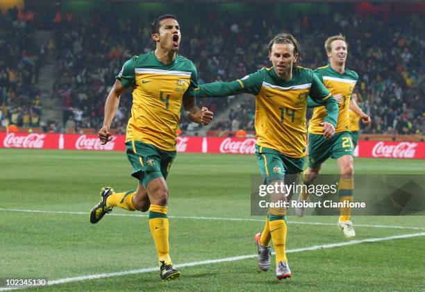 Tim Cahill of Australia celebrates scoring the opening goal with team mates Brett Holman and David Carney during the 2010 FIFA World Cup South Africa...