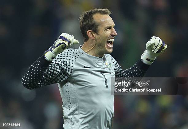 Mark Schwarzer of Australia celebrates Brett Holman scoring his side's second goal during the 2010 FIFA World Cup South Africa Group D match between...