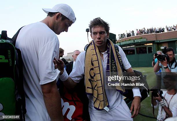 John Isner of USA and Nicolas Mahut of France prepare to leave court 18 as light stops play at 59-59 in the last set on Day Three of the Wimbledon...