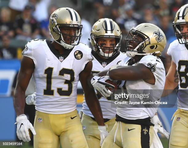 Austin Carr and Michael Thomas celebrate after a touchdown by Alvin Kamara of the New Orleans Saints in the second quarter of the preseason game...