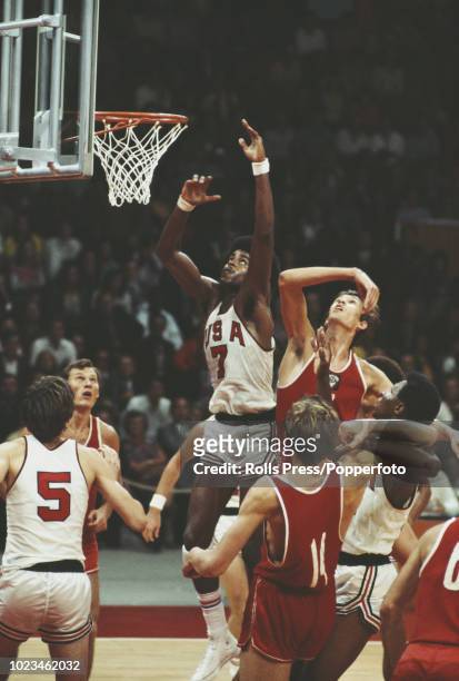 View of action between the Soviet Union and United States teams , with Mike Bantom in the air, in the final of the Basketball event at the 1972...