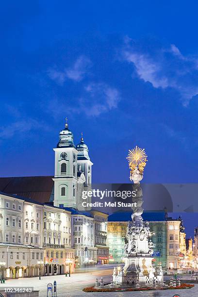 austria, linz, old cathedral with trinity column - linz stock pictures, royalty-free photos & images