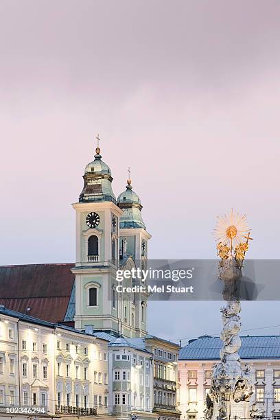 austria, linz, old cathedral with trinity column - linz stock pictures, royalty-free photos & images