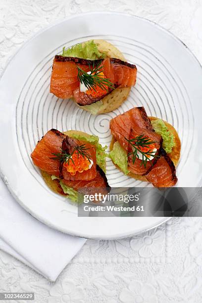 appetiser, canapes with salmon, dill and trout caviar on plate, elevated view - fish roe stock pictures, royalty-free photos & images
