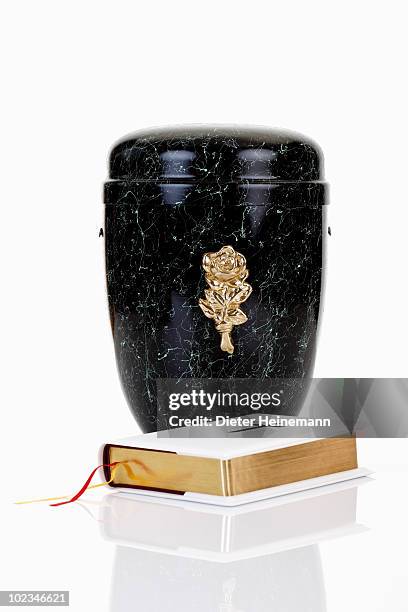 cremation urn and bible - grecian urns stock-fotos und bilder