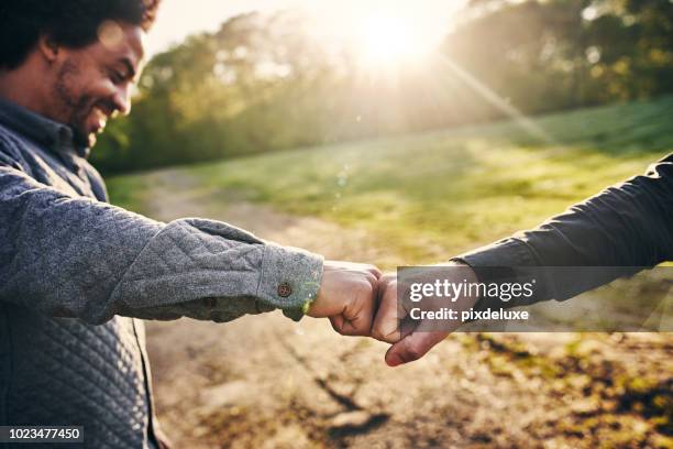 the official greeting of bros - fist bump stock pictures, royalty-free photos & images
