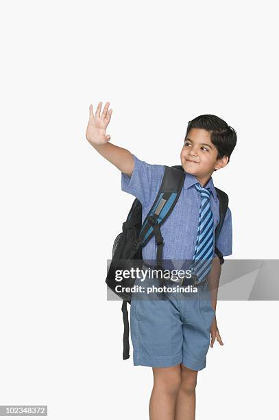 schoolboy leaving for the school - waving hands goodbye photos et images de collection