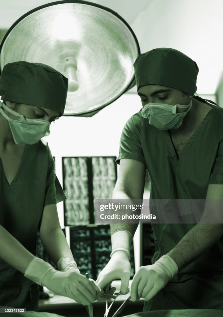 Surgeons performing surgery in an operating room
