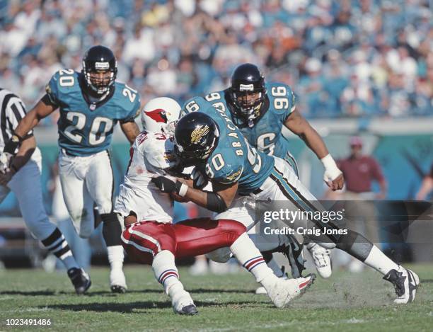 Tony Brackens, Defensive End for the Jacksonville Jaguars tackles Michael Pittman, Running Back of the Arizona Cardinals during their American...