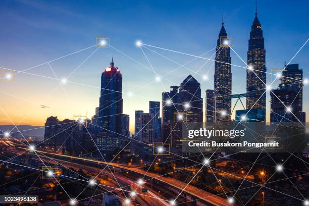 city scape and network connection concept.digital skyscrappers with wire texture. technology and connection concept. - malaysia city stock pictures, royalty-free photos & images