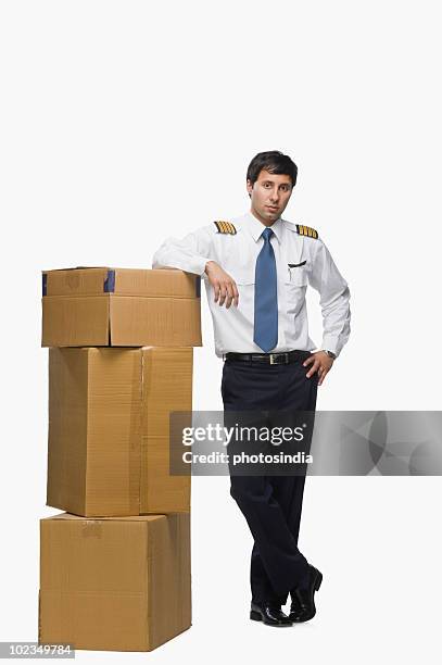pilot leaning against cardboard boxes - leaning on elbows stock pictures, royalty-free photos & images