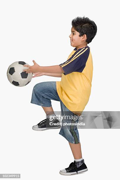 boy playing with a soccer ball - indian boy standing stock pictures, royalty-free photos & images