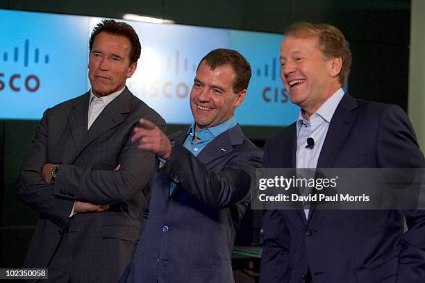 Russian President Dmitry Medvedev laughs with Cisco Chairman and CEO John Chambers and California Gov. Arnold Schwarzenegger during a demonstration...