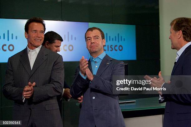 Russian President Dmitry Medvedev claps his hands with Cisco Chairman and CEO John Chambers and California Gov. Arnold Schwarzenegger at the...