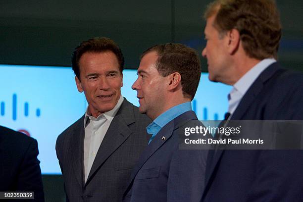 Russian President Dmitry Medvedev listens to Cisco Chairman and CEO John Chambers as California Gov. Arnold Schwarzenegger looks on during a...