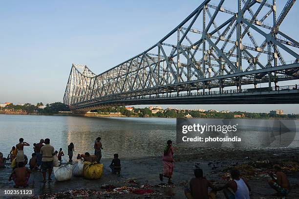 bridge across the river, howrah bridge, hooghly river, kolkata, west bengal, india - howrah bridge stock pictures, royalty-free photos & images