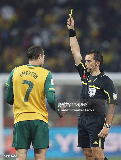 Brett Emerton of Australia receives a yellow card from referee Jorge Larrionda during the 2010 FIFA World Cup South Africa Group D match between...