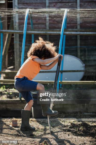 determined digging at the allotment - kid stomping feet stock pictures, royalty-free photos & images
