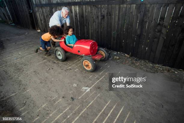 go-kart fun with grandad - man pushing cart fun play stock pictures, royalty-free photos & images