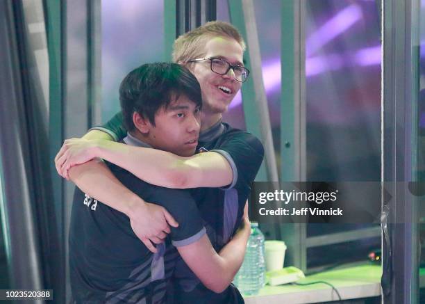Anathan Pham and Topias Taavitsainen of OG hug after their 3-2 win over PSG.LGD in their grand final Dota 2 match on Day 6 of The International 2018...