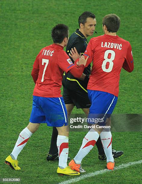 Zoran Tosic and Danko Lazovic of Serbia speak to referee Jorge Larrionda during the 2010 FIFA World Cup South Africa Group D match between Australia...