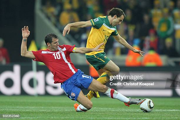Dejan Stankovic of Serbia tackles Richard Garcia of Australia during the 2010 FIFA World Cup South Africa Group D match between Australia and Serbia...