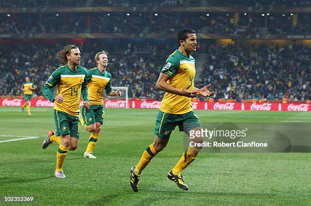 Tim Cahill of Australia celebrates scoring the opening goal during the 2010 FIFA World Cup South Africa Group D match between Australia and Serbia at...