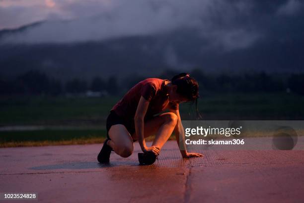 female runner injury after workout running on track - sport injury stock pictures, royalty-free photos & images