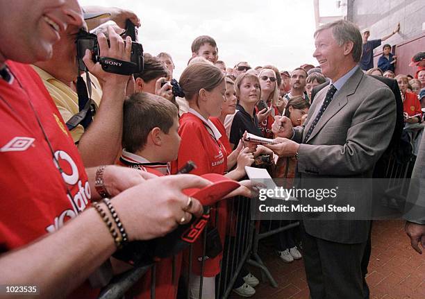 Sir Alex Ferguson the Manchester United manager signs autographs for fans at the new Manchester United Team kit launch at Old Trafford, Manchester....