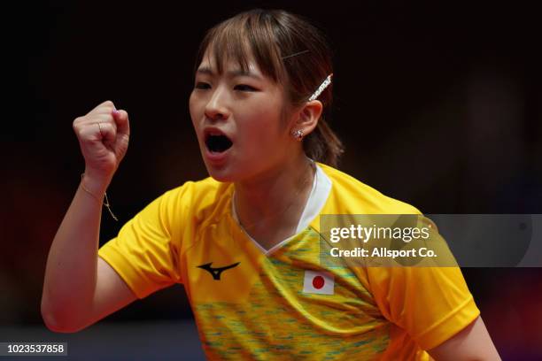 Maeda Miyu of Japan reacts after scoring a point against Komwong Nanthana of Thailand during the Women's Team Table Tennis Group 2 match against...