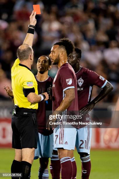 Referee Ted Unkel issues a red card to Bismark Adjei-Boateng of the Colorado Rapids, right, against Real Salt Lake at Dick's Sporting Goods Park on...