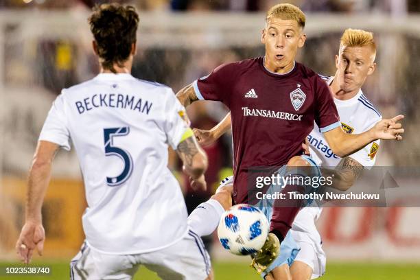 Dillon Serna of the Colorado Rapids controls the ball between Kyle Beckerman and Justen Glad of Real Salt Lake at Dick's Sporting Goods Park on...