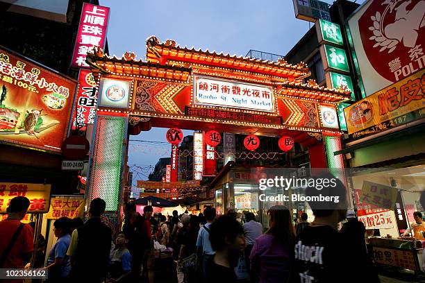 Decorated archway is lit up at a night market in Taipei, Taiwan, on Saturday, May 8, 2010. About 54 million Chinese may travel abroad this year, and...
