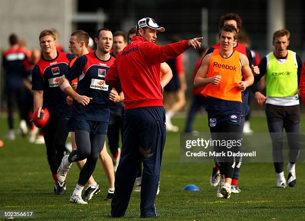 Assistant Coach Sean Wellman instructs players during a Melbourne Demons AFL training session at their new training oval adjacent to AAMI Park on...