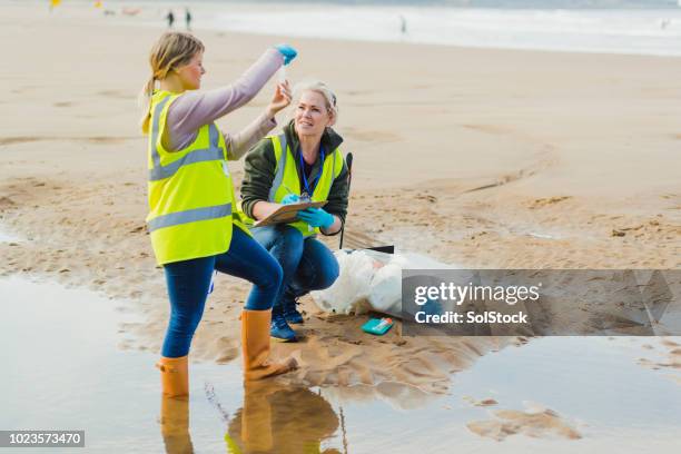 biotechnology woman engineer examining sea water samples - marine biologist stock pictures, royalty-free photos & images