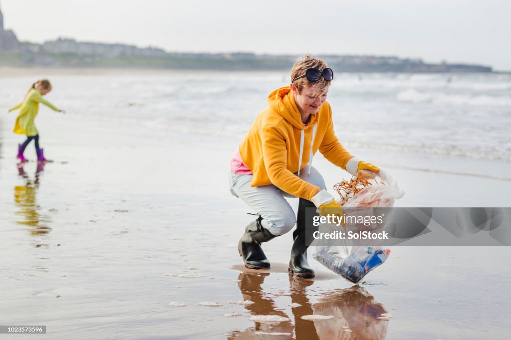 Environmentally Conscious Woman Cleans Up Beach High-Res Stock Photo ...