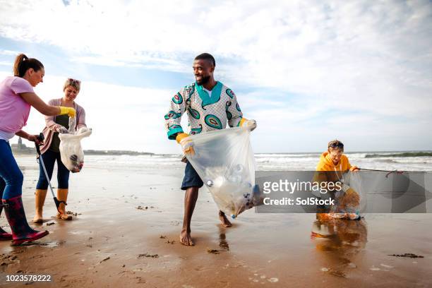 activists working together making a difference - plastic pollution beach stock pictures, royalty-free photos & images
