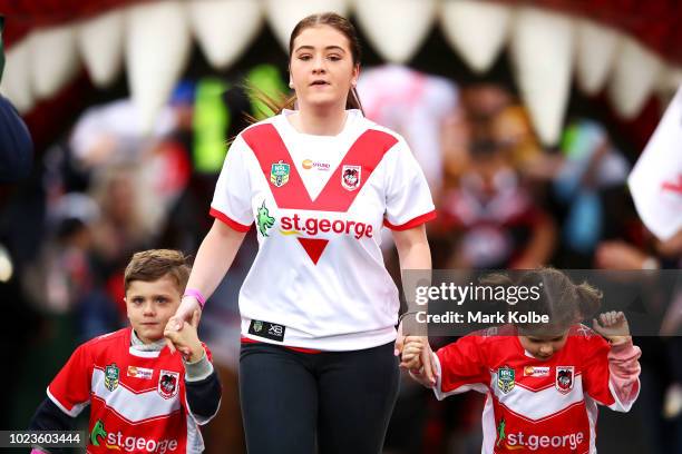 The children of former Dragons and Sharks NRL player Lance Thompson lead the Dragons team out during the round 24 NRL match between the St George...