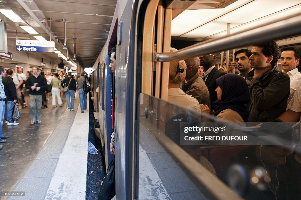 Commuters wait for the departure of a RE