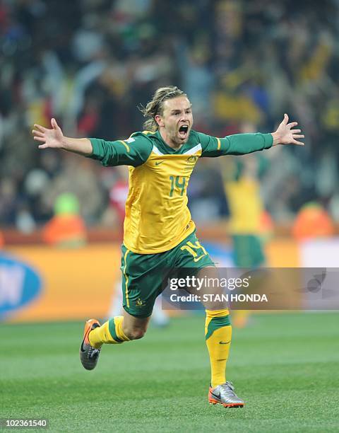 Australia's striker Brett Holman celebrates with teammates after scoring during the Group D first round 2010 World Cup football match Australia vs....