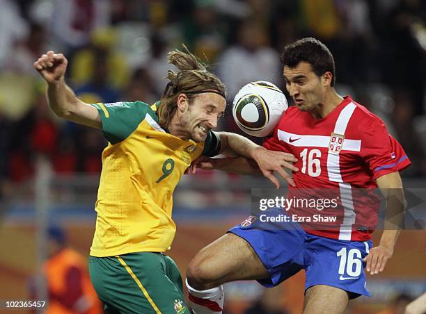 Joshua Kennedy of Australia goes up for the ball against Ivan Obradovic of Serbia during the 2010 FIFA World Cup South Africa Group D match between...