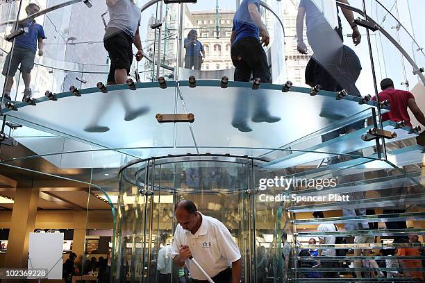 Customers enter the flagship Apple Store on Fifth Avenue for the new iPhone 4, which went on sale this morning on June 24, 2010 in New York City....