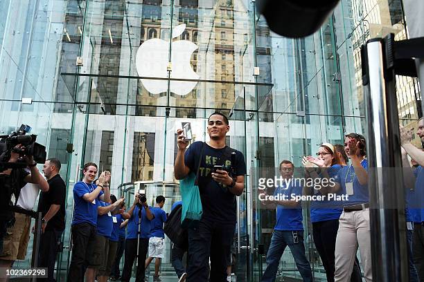 One of the first customers in line at the flagship Apple Store on Fifth Avenue displays his new iPhone 4, which went on sale this morning on June 24,...