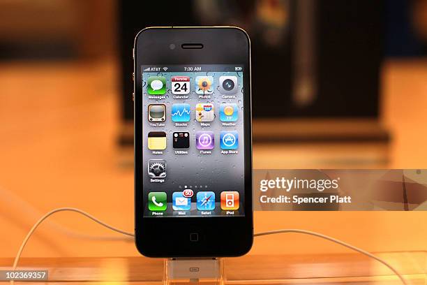 The new iPhone 4, which went on sale this morning, is displayed at the flagship Apple Store on Fifth Avenue on June 24, 2010 in New York City. People...