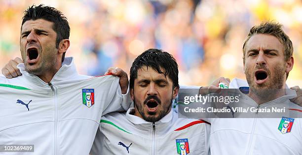 Vincenzo Iaquinta, Gennaro Gattuso and Daniele De Rossi of Italy sing their national anthem prior to the 2010 FIFA World Cup South Africa Group F...